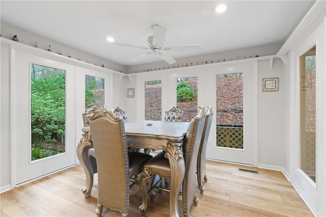dining room featuring ceiling fan, plenty of natural light, french doors, and light wood-type flooring