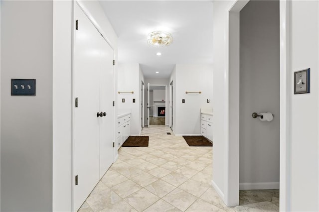 hall featuring baseboards and recessed lighting