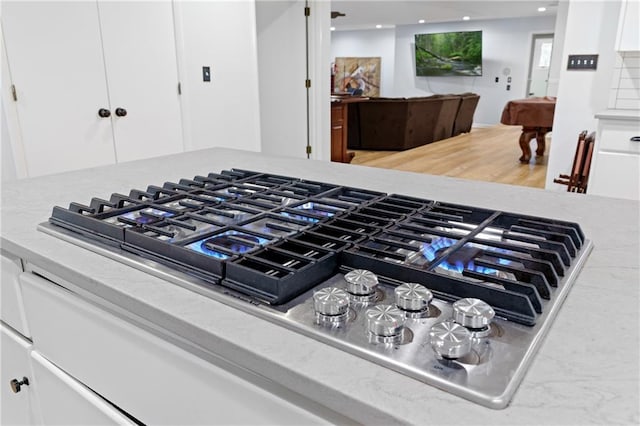 details featuring white cabinetry, recessed lighting, and stainless steel gas stovetop