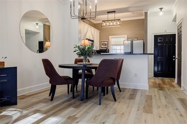 dining area featuring ornamental molding and light hardwood / wood-style flooring