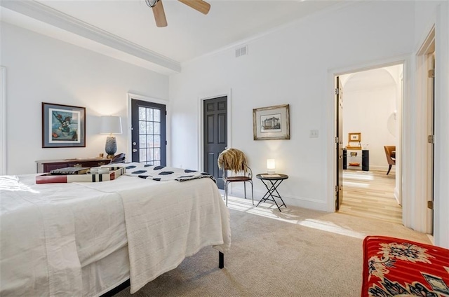 carpeted bedroom featuring crown molding and ceiling fan