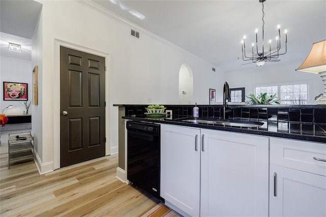 kitchen with white cabinets, hanging light fixtures, sink, and dishwasher