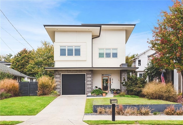 contemporary house featuring fence, a front yard, stucco siding, a garage, and driveway