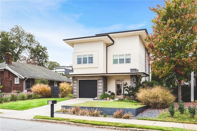 contemporary house featuring stucco siding, driveway, an attached garage, and a front lawn