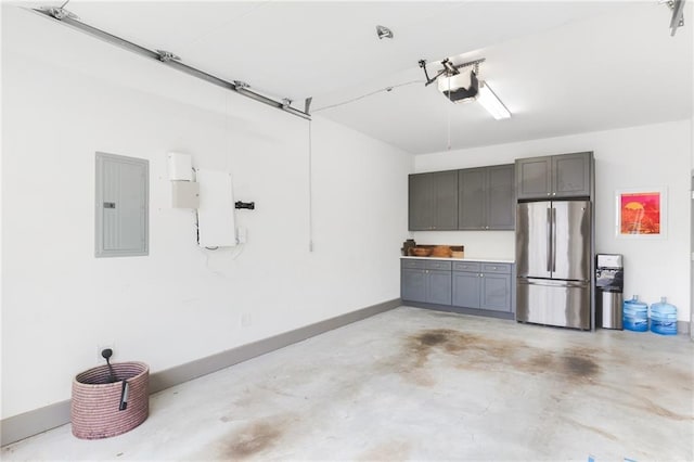 garage featuring electric panel, a garage door opener, freestanding refrigerator, and baseboards