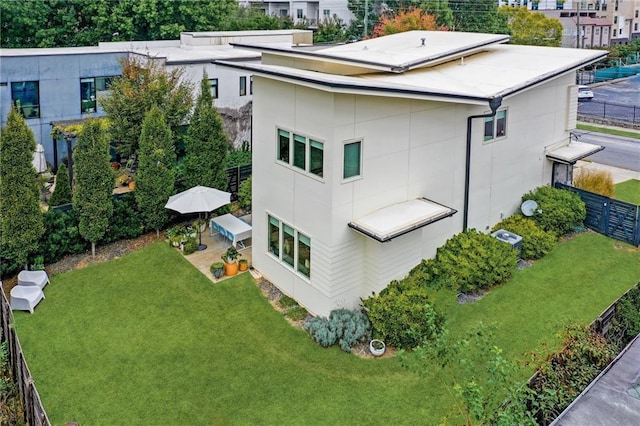 exterior space with a lawn and fence