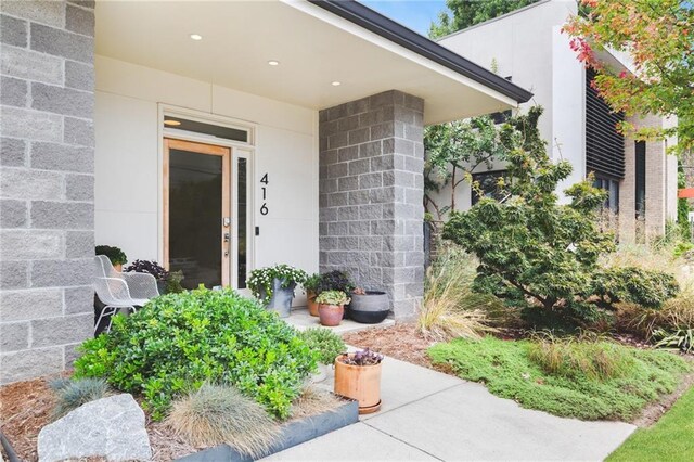 view of exterior entry featuring concrete block siding