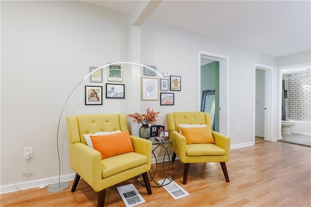 sitting room featuring light hardwood / wood-style floors