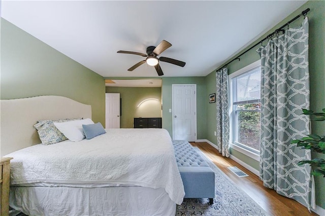 bedroom with wood-type flooring and ceiling fan