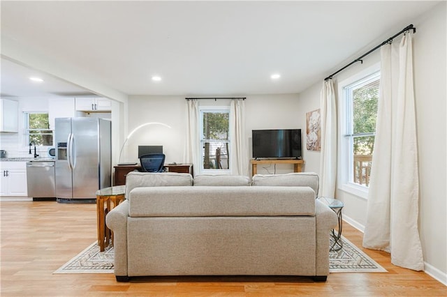 living room featuring plenty of natural light and light wood-type flooring