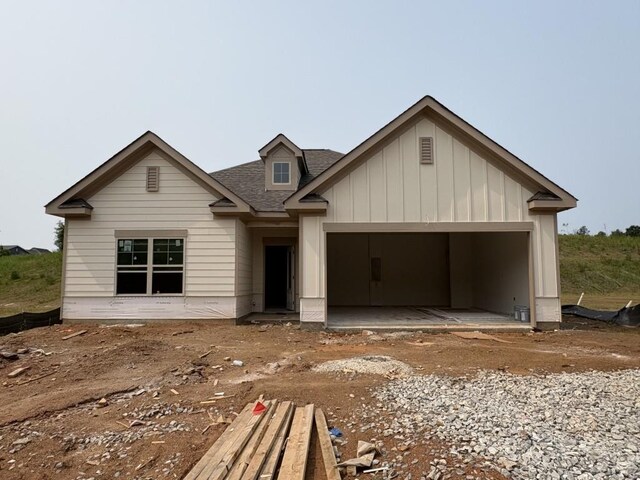 174 Greenview Ct, Homer, GA 30547 - view of front of property featuring board and batten siding, an attached garage, a front lawn, concrete driveway, and a shingled roof