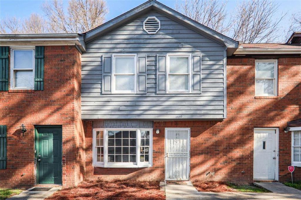 view of property featuring brick siding