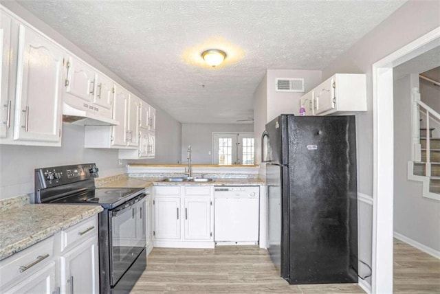 kitchen featuring light wood-style flooring, a sink, black appliances, white cabinets, and under cabinet range hood