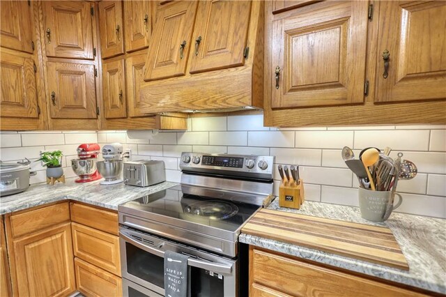 78 N Pomona Rd, Hampton, GA 30228 - kitchen featuring electric range, light countertops, backsplash, and brown cabinets