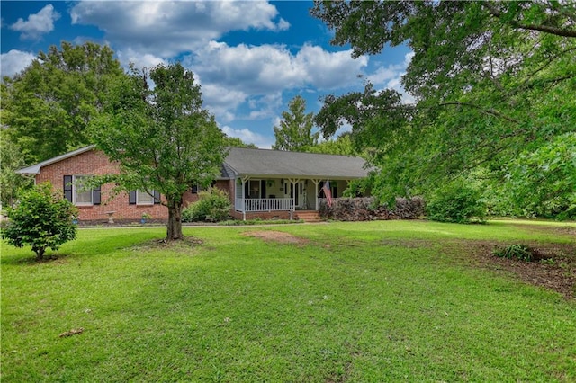 78 N Pomona Rd, Hampton, GA 30228 - ranch-style home with a porch, a front yard, and brick siding