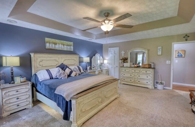 78 N Pomona Rd, Hampton, GA 30228 - carpeted bedroom with a tray ceiling, ceiling fan, baseboards, and a textured ceiling