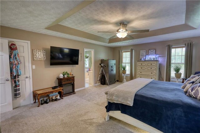 78 N Pomona Rd, Hampton, GA 30228 - bedroom featuring a textured ceiling, a raised ceiling, multiple windows, carpet flooring, and ceiling fan