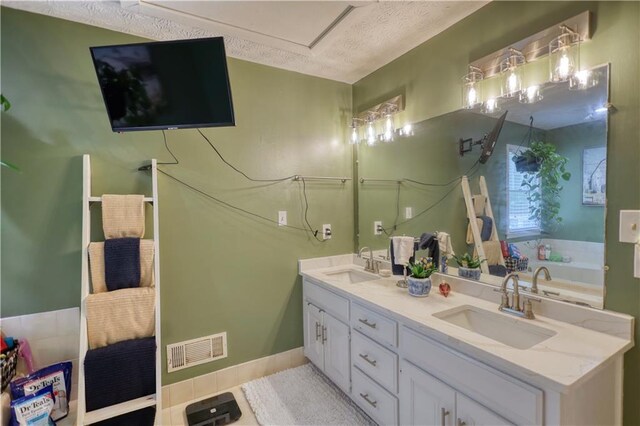 78 N Pomona Rd, Hampton, GA 30228 - bathroom with double vanity, a textured ceiling, a garden tub, and tile patterned floors