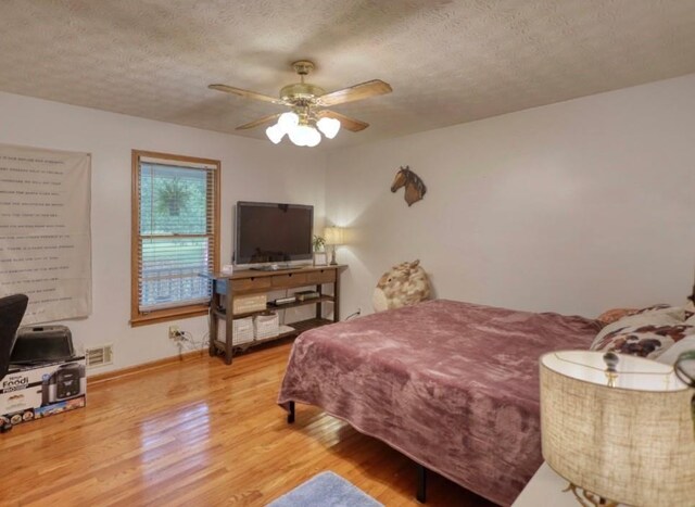 78 N Pomona Rd, Hampton, GA 30228 - bedroom with wood finished floors, a textured ceiling, baseboards, and ceiling fan