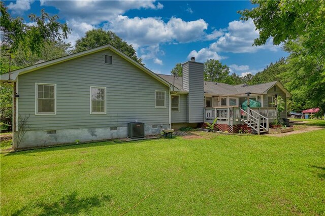 78 N Pomona Rd, Hampton, GA 30228 - rear view of house with crawl space, cooling unit, a wooden deck, a chimney, and a yard
