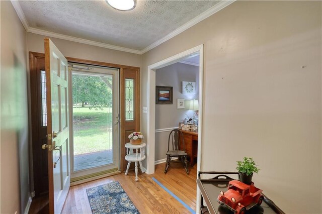 78 N Pomona Rd, Hampton, GA 30228 - foyer featuring light wood-style floors, crown molding, and baseboards