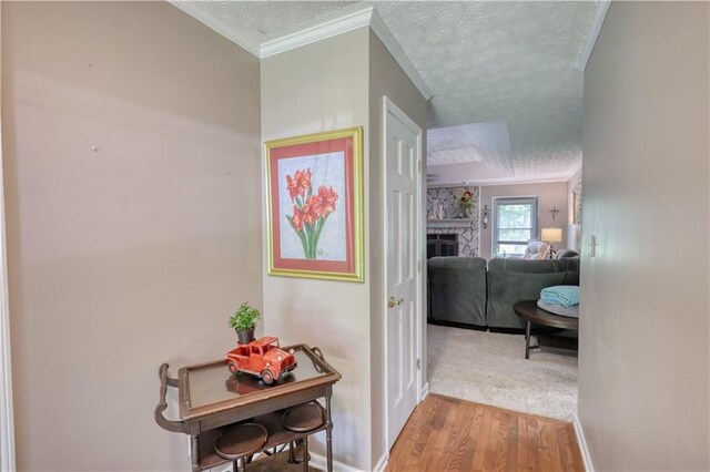 78 N Pomona Rd, Hampton, GA 30228 - hallway with a textured ceiling, wood finished floors, baseboards, and crown molding