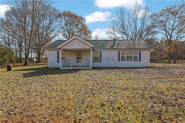 ranch-style house with a porch and a front lawn