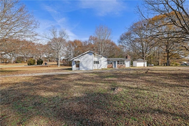 view of side of property with a yard