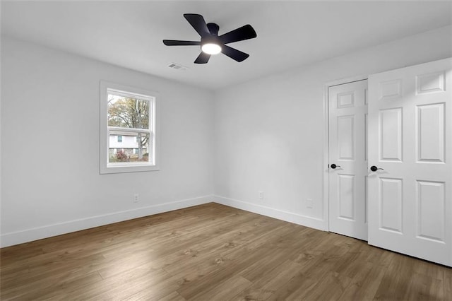 9148 Homewood Dr, Riverdale, GA 30274 - unfurnished bedroom featuring wood finished floors, baseboards, a ceiling fan, and visible vents