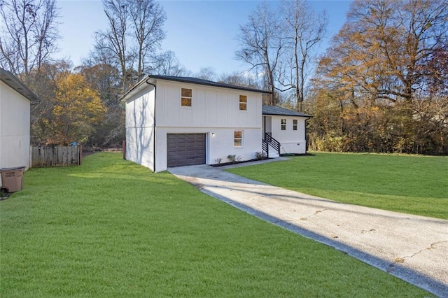 9148 Homewood Dr, Riverdale, GA 30274 - view of front of property with driveway, a garage, fence, and a front yard