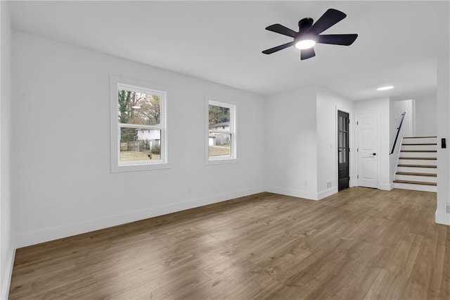 9148 Homewood Dr, Riverdale, GA 30274 - spare room featuring stairs, ceiling fan, baseboards, and wood finished floors