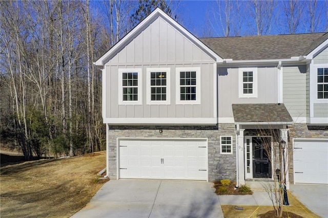 93 Portico Pl, Newnan, GA 30265 - view of front of property with an attached garage, concrete driveway, board and batten siding, and stone siding