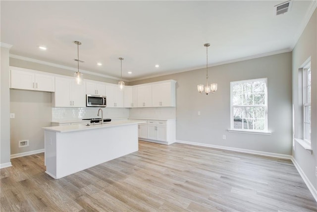 unfurnished living room featuring crown molding and light wood-type flooring