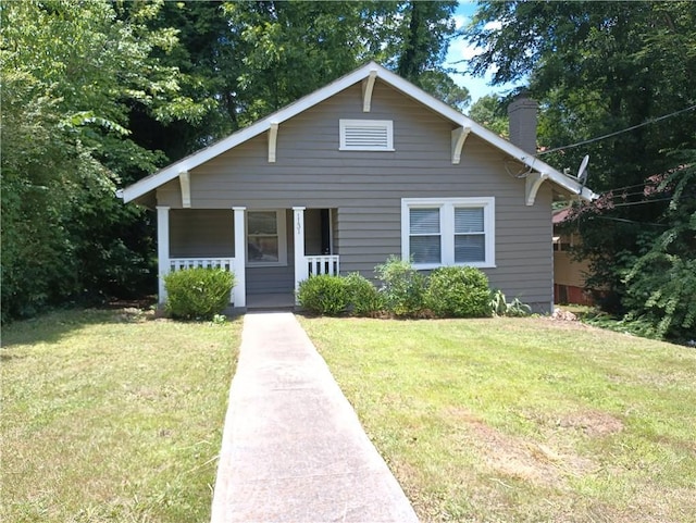 1131 Indale Pl SW, Atlanta, GA 30310 - bungalow with covered porch, a chimney, and a front yard