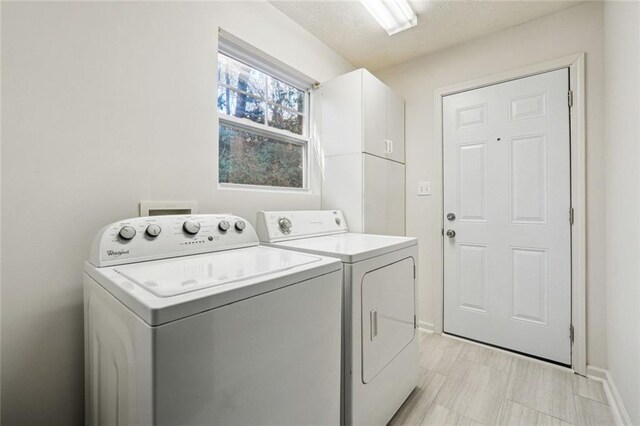 laundry area with cabinets and separate washer and dryer