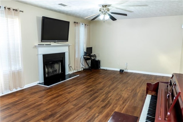 unfurnished living room with hardwood / wood-style floors, a textured ceiling, and ceiling fan