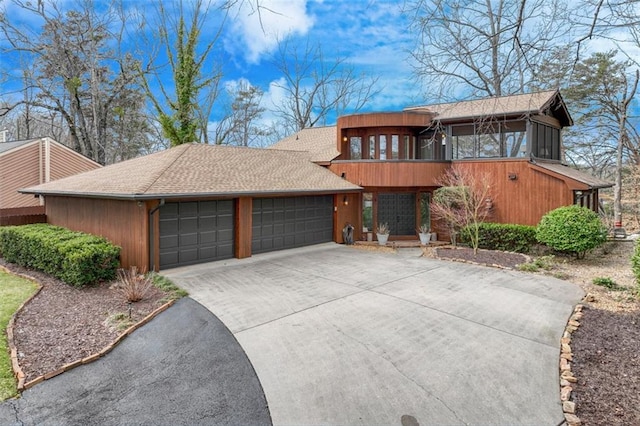 contemporary house with a garage and a sunroom