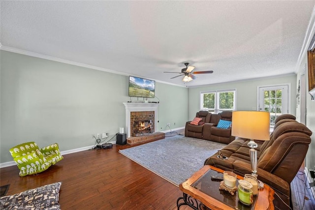 2196 Kildare Way NW, Kennesaw, GA 30152 - living room with ornamental molding, a brick fireplace, wood-type flooring, ceiling fan, and baseboards