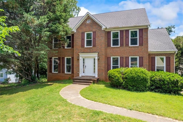 2196 Kildare Way NW, Kennesaw, GA 30152 - colonial house featuring a shingled roof, a front yard, and brick siding