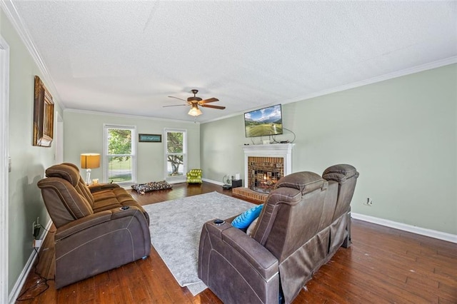 2196 Kildare Way NW, Kennesaw, GA 30152 - living room with a brick fireplace, a textured ceiling, ornamental molding, a ceiling fan, and wood finished floors