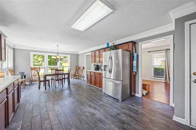 2196 Kildare Way NW, Kennesaw, GA 30152 - kitchen featuring stainless steel fridge with ice dispenser, a textured ceiling, dark wood finished floors, ornamental molding, and light countertops