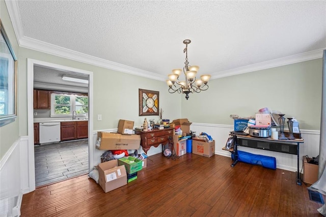 2196 Kildare Way NW, Kennesaw, GA 30152 - dining area featuring a chandelier, a wainscoted wall, ornamental molding, hardwood / wood-style floors, and a textured ceiling