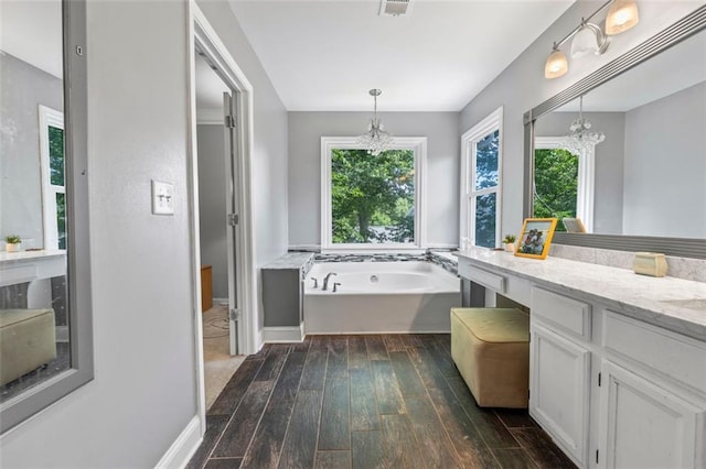 2196 Kildare Way NW, Kennesaw, GA 30152 - bathroom featuring a chandelier, wood finished floors, a bath, and vanity