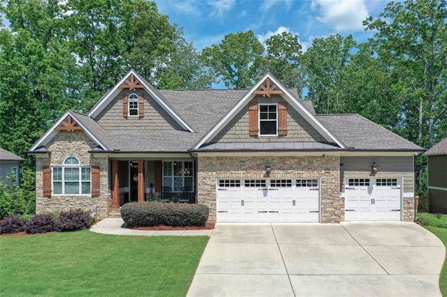 295 Hanover Dr, Villa Rica, GA 30180 - craftsman-style house featuring an attached garage, stone siding, concrete driveway, and a front lawn