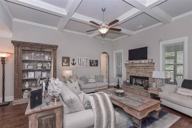 295 Hanover Dr, Villa Rica, GA 30180 - living area featuring dark wood finished floors, arched walkways, coffered ceiling, ceiling fan, and a stone fireplace