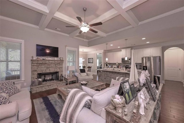 295 Hanover Dr, Villa Rica, GA 30180 - living area featuring wood finished floors, a ceiling fan, arched walkways, coffered ceiling, and beamed ceiling