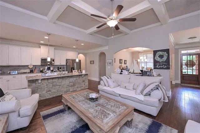 295 Hanover Dr, Villa Rica, GA 30180 - living area with coffered ceiling, arched walkways, baseboards, a ceiling fan, and dark wood-style flooring