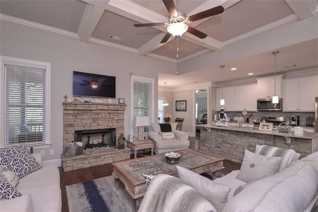 295 Hanover Dr, Villa Rica, GA 30180 - living room with coffered ceiling, ceiling fan, a stone fireplace, plenty of natural light, and beamed ceiling