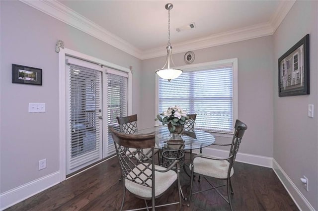 295 Hanover Dr, Villa Rica, GA 30180 - dining room featuring healthy amount of natural light, wood finished floors, baseboards, and crown molding