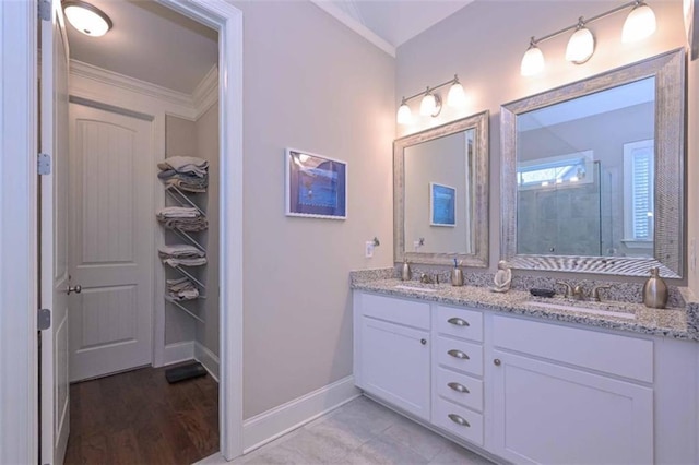 295 Hanover Dr, Villa Rica, GA 30180 - bathroom with baseboards, crown molding, a tile shower, and double vanity